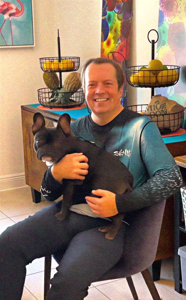 Stephen calmly holding a French Bulldog while assessing the area